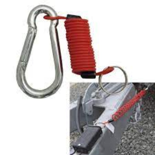 A silver metal carabiner attached to a red coiled rope with a key ring, shown on a white background with a small inset photo demonstrating its use on a trailer hitch.